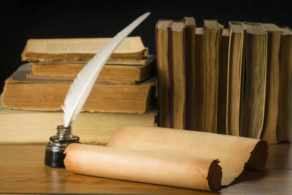 Scroll of old paper for background old books, inkwell and pen Stock Image
