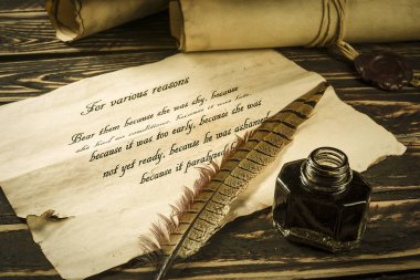 Roll of parchment with a pen and inkwel clipart