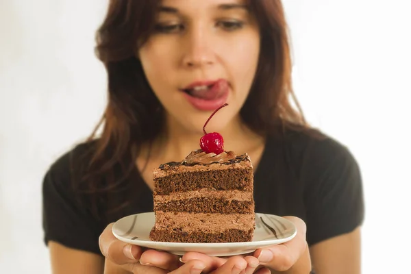 Cheerful young woman is eating tasty food — Stock Photo, Image