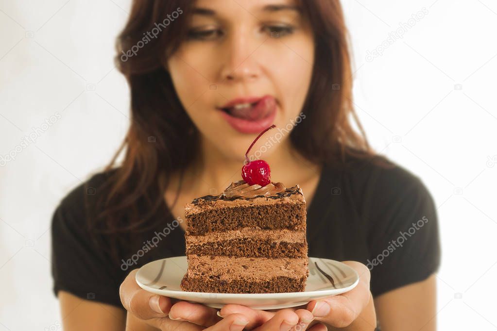 Cheerful young woman is eating tasty food 