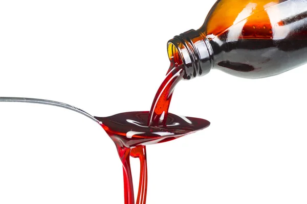 Bottle pouring Medicine Syrup in Spoon — Stock Photo, Image
