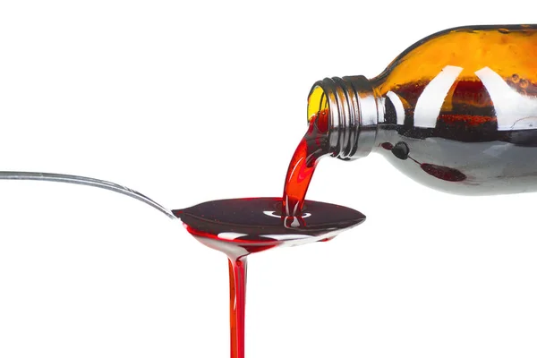 Bottle pouring Medicine Syrup in Spoon — Stock Photo, Image