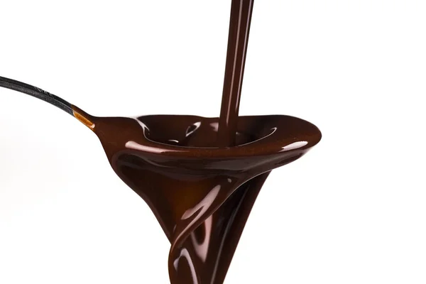 Cucharada de chocolate sobre el fondo blanco — Foto de Stock