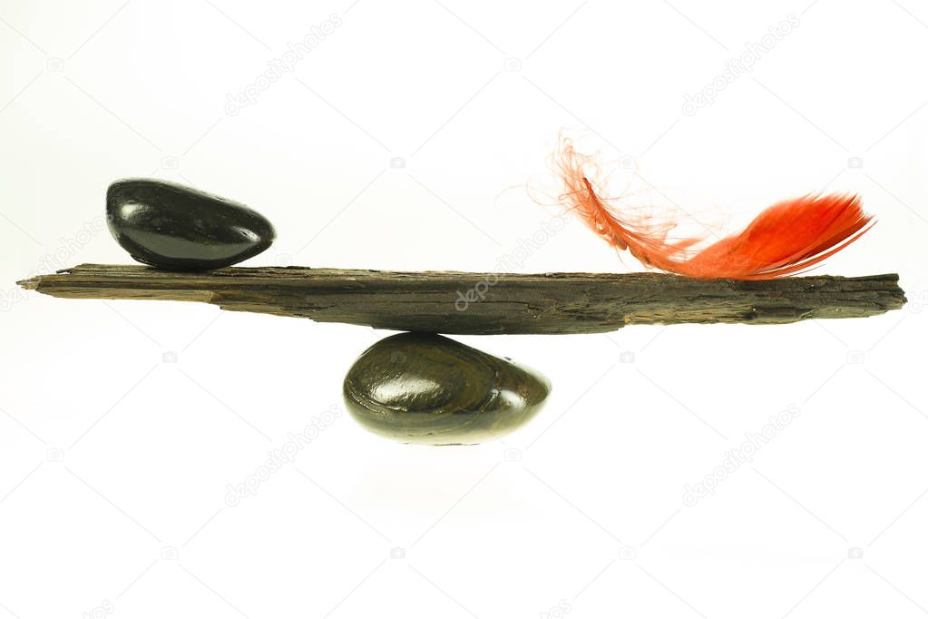 The natural balance beam, the red feather and the stone 