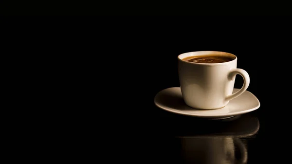 Coffee in the white cup on the black background