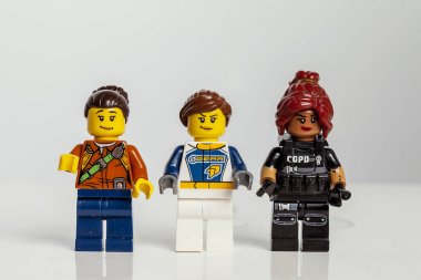 KIEV, UKRAINE - May 10, 2018: three lego figures lined up in a row on a white background. Macro. Lego Minifigures are manufactured by Lego Group. clipart