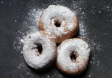 Siyah arkaplanda krema şekerli çörekler