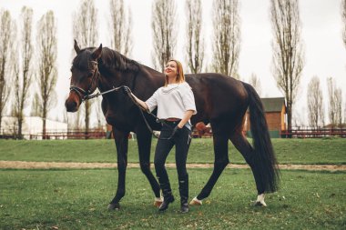 Güzel kız parkta bir at ile iletişim kurar