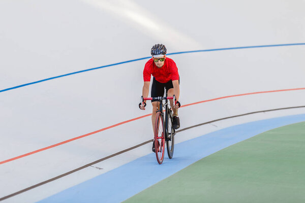 Racing cyclist on velodrome outdoor