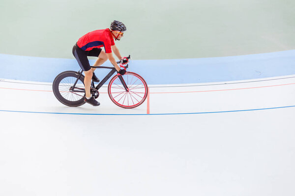 Racing cyclist on velodrome outdoor