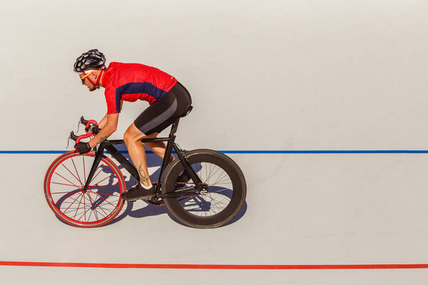 Racing cyclist on velodrome outdoor