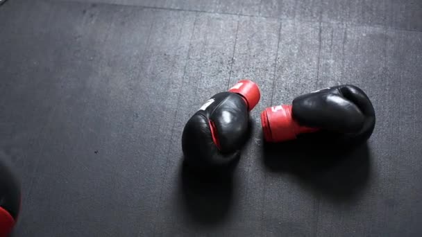 Luvas de boxe e bola med deitado no chão — Vídeo de Stock