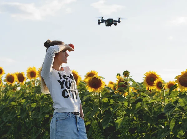 Beautiful young woman doing selfie and posing on a mini drone