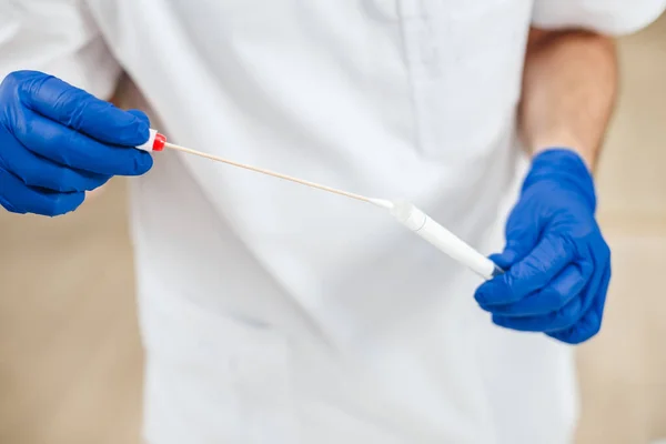 Närbild Dna test tube och bomullspinne, torka test i mannen händer — Stockfoto