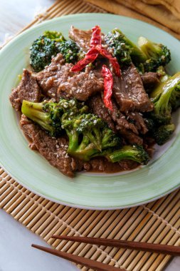 Szechuan stir fried beef with broccoli and hot peppers clipart