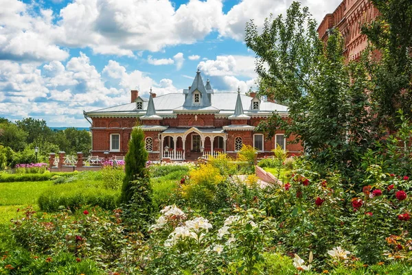 Beautiful old house among flowers — Stock Photo, Image