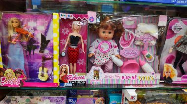 Çocuklar için çok güzel oyuncaklar. Renkli bebekler, araba, kız bebek, erkek bebek. Süpermarket raflarında pembe paketler.