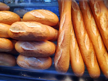 Saigon / Vietnam - 01 May 2019: Delicious fresh baguette bread newly baked in bakery shop Banh Mi crunchy wheat pastry. Delicious bread cheese knot with package healthy breakfast