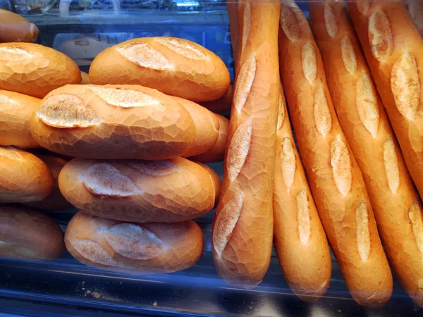 Saigon / Vietnam - 01 May 2019: Delicious fresh baguette bread newly baked in bakery shop Banh Mi crunchy wheat pastry. Delicious bread cheese knot with package healthy breakfast