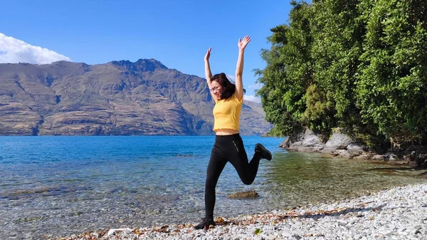 young woman practicing yoga in the mountains