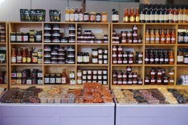 Cromwell/ New Zealand: 1 Apr 2019: Jam fruit jar on wooden shelf strawberry apricot raspberry homemade fresh preserve on farmer market 