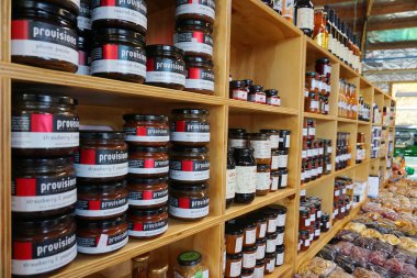 Cromwell/ New Zealand: 1 Apr 2019: Jam fruit jar on wooden shelf strawberry apricot raspberry homemade fresh preserve on farmer market 