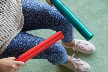boomwhackers and percussion tubes playing over the legs clipart