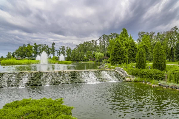 Landscaping. Beautiful pond with fountain in green park at Mezhgorye residence, Ukraine