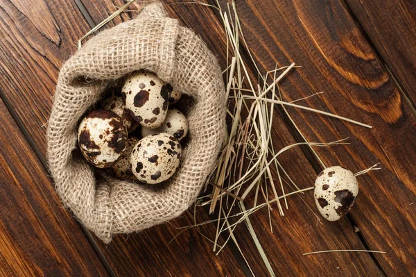 çuvala eski ahşap arka plan üzerinde bıldırcın yumurtası üzerinde Üstten Görünüm