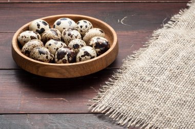 bıldırcın yumurtası karanlık eski ahşap arka plan üzerinde ahşap plaka