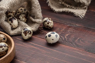 çuvala eski ahşap arka plan üzerinde bıldırcın yumurtası