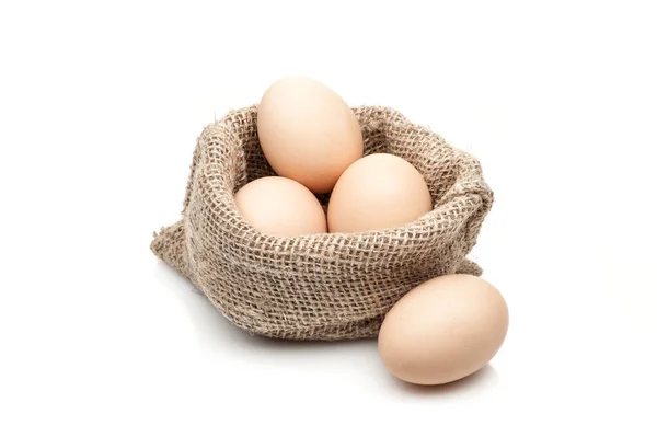 Chicken eggs in burlap sack isolated on white background — Stock Photo, Image