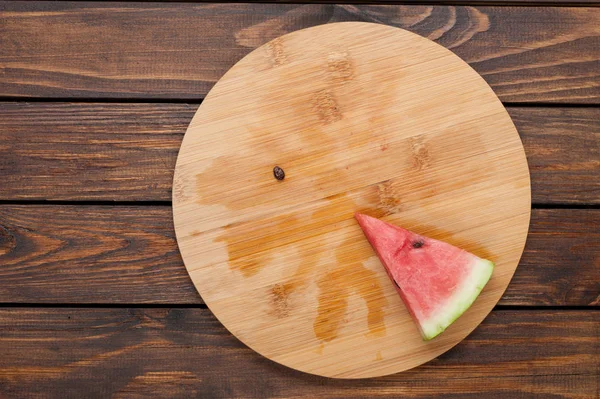 Watermelon slice on dark wooden background top view — Stock Photo, Image