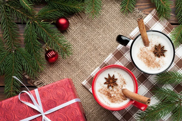 Eggnog cocktail in  mug arranged with christmas decoration on wo — Stock Photo, Image
