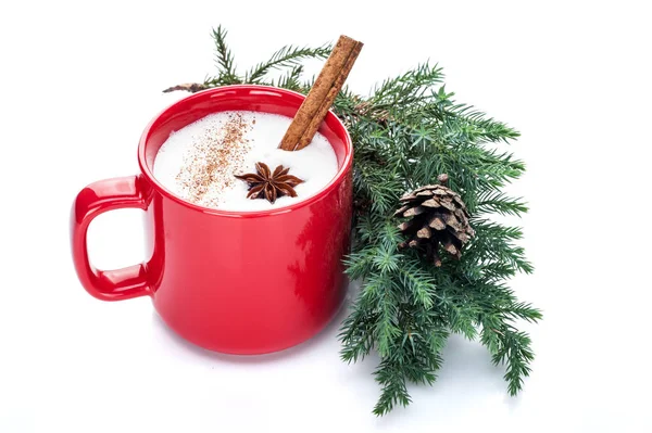 eggnog cocktail in red mug arranged with christmas decoration is
