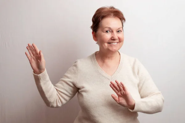 Adult woman on a white background in a light sweater. Emotions — Stock Photo, Image