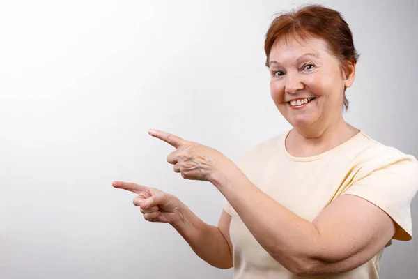 Beautiful Senior Woman Shows Hand Side White Background Light Shirt — Stock Photo, Image