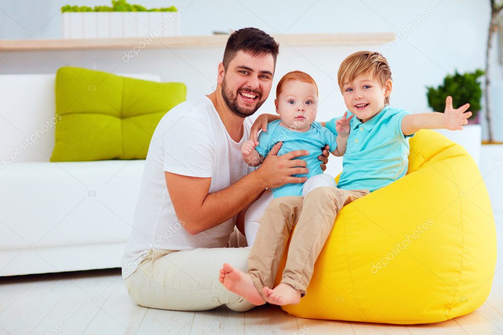 happy father with six month and six years old sons, at home