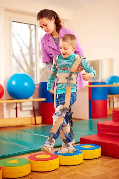 Schattige jongen met musculoskeletale fysiotherapie in revalidatiecentrum — Stockfoto