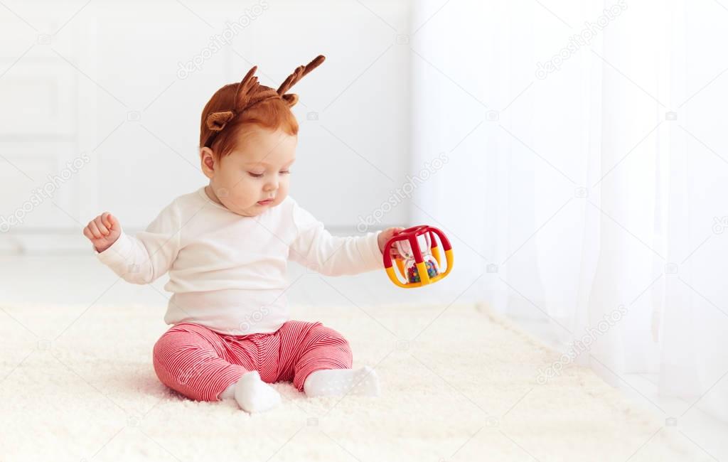 beautiful baby dear playing with toy at home