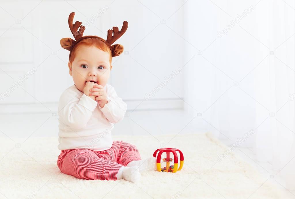 beautiful baby dear playing with toy at home