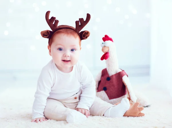 Cute redhead baby with rooster toy at home — Stock Photo, Image