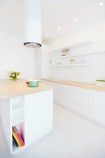 White wooden kitchen with island cooker hood and hanging shelves — Stock Photo, Image