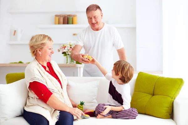 Glückliche Großeltern, die zu Hause mit ihrem Enkel spielen — Stockfoto