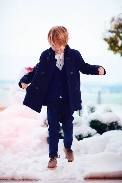 Fashion, seven years old boy in coat outdoors — стоковое фото