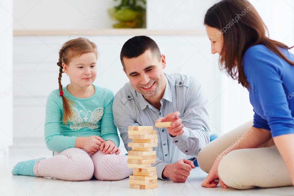 happy family playing jenga game at home