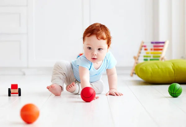 Cute infant baby crawling on the floor at home, playing with colorful balls — Stock Photo, Image