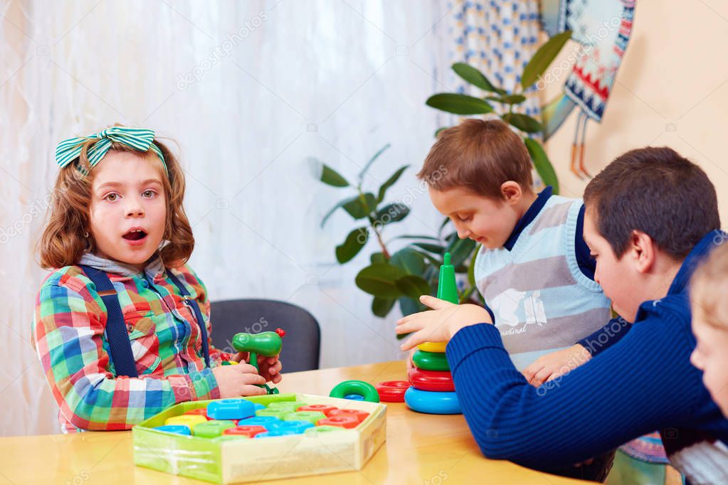 group of kids playing together in daycare center for kids with special needs