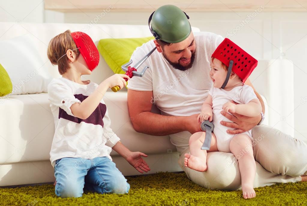 father with sons playing in war games at home