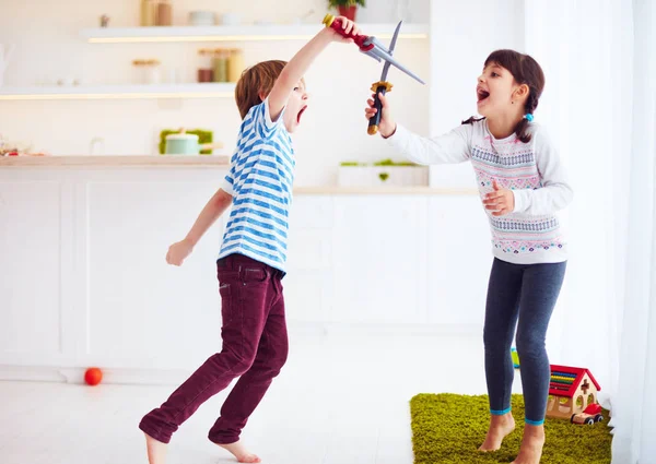 Kids playing active fight games at home kitchen — Stock Photo, Image